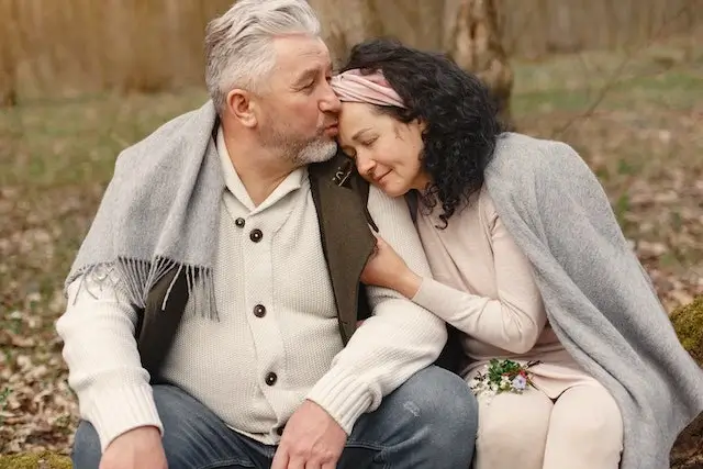 Husband and Wife kissing on forehead